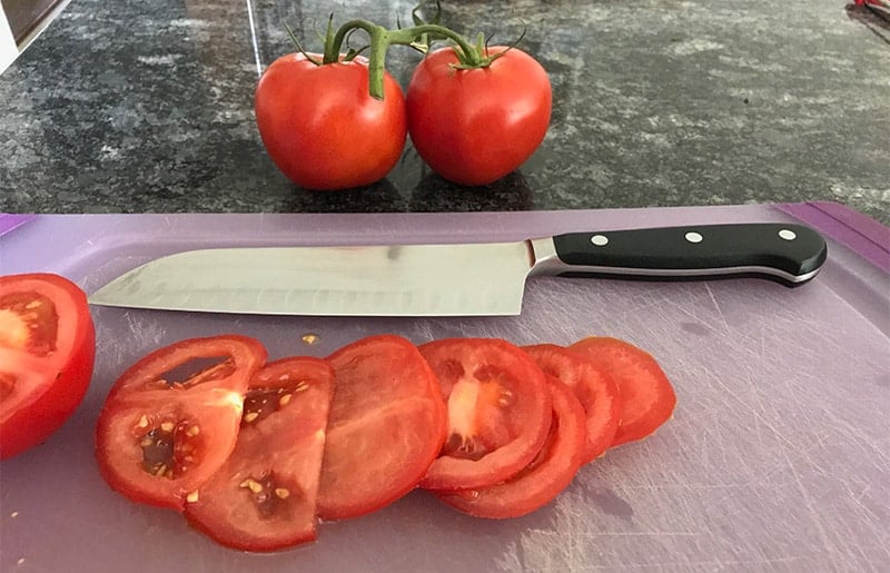 https://prudentreviews.com/wp-content/uploads/2019/07/Wusthof-Classic-Santoku-Knife-Cutting-Tomatoes.jpg