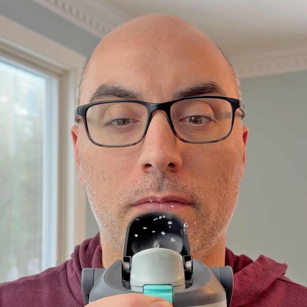 Andrew Palermo Founder of Prudent Reviews showing how water flicks backward when opening Owala FreeSip Sway lid