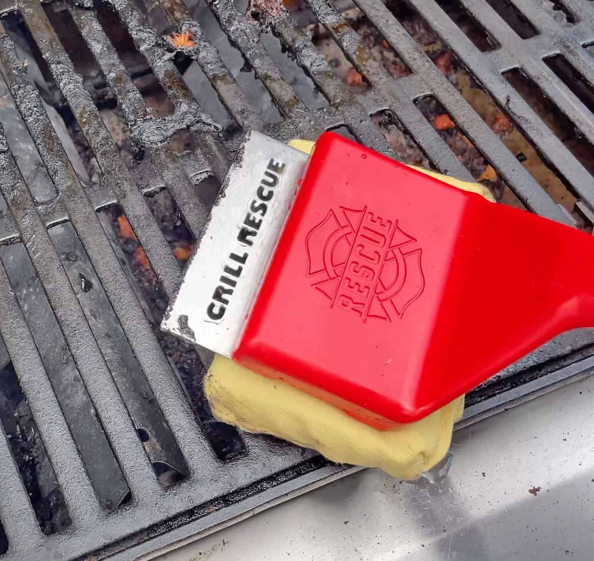 Cleaning dirty grill grates with Grill Rescue grill brush