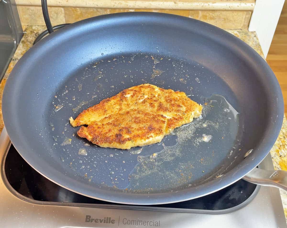 Cooking a chicken cutlet on a Made In non-stick pan on an induction cooktop