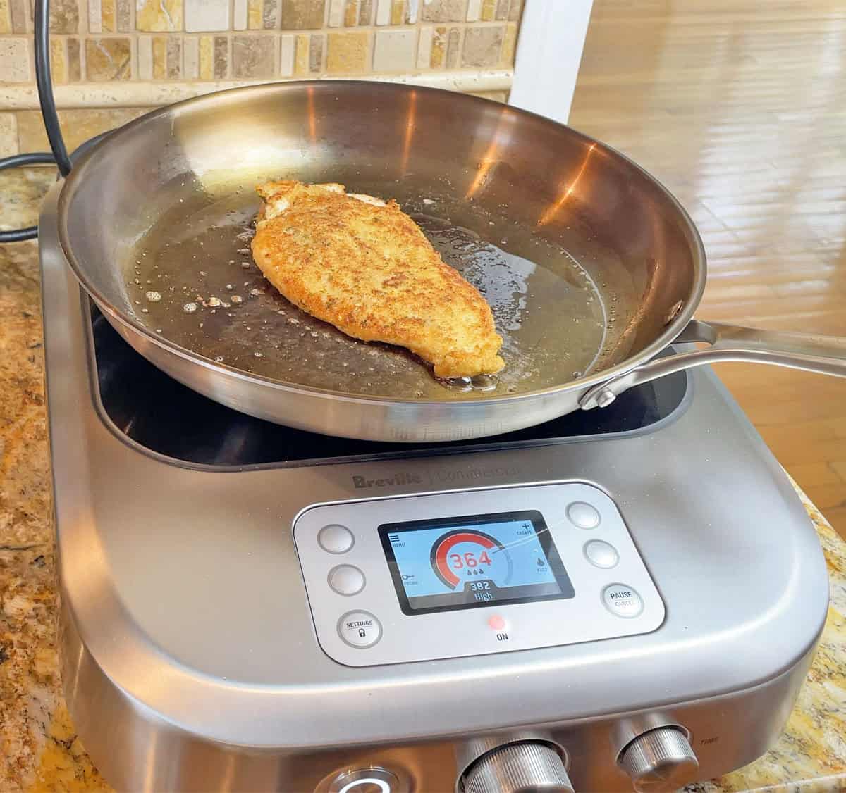 Cooking a chicken cutlet on a Strata pan on an induction cooktop