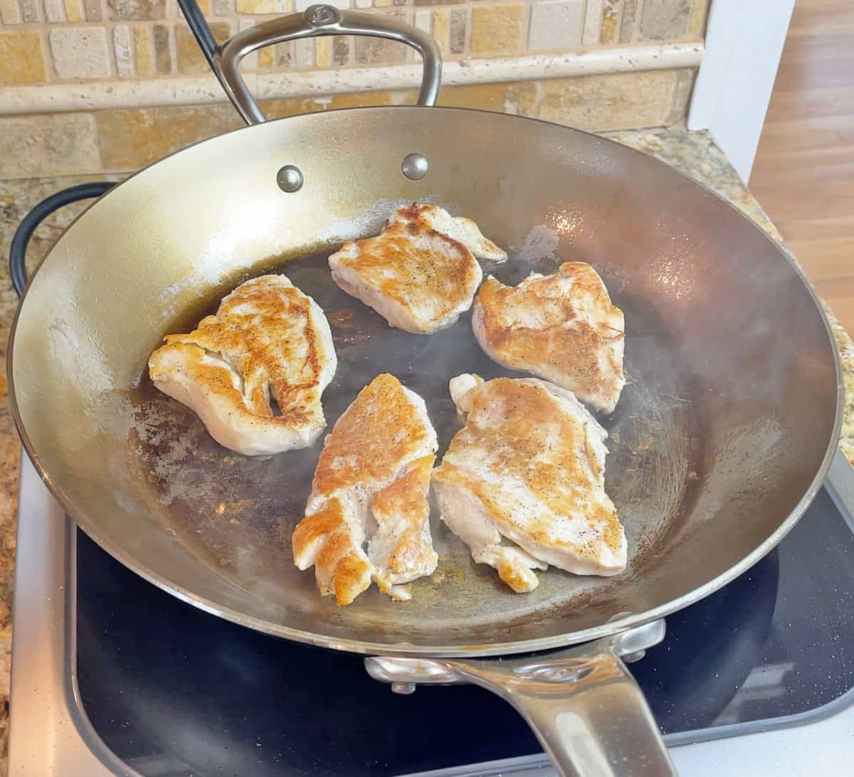 Cooking a chicken on a de Buyer Mineral B Pro pan on an induction cooktop