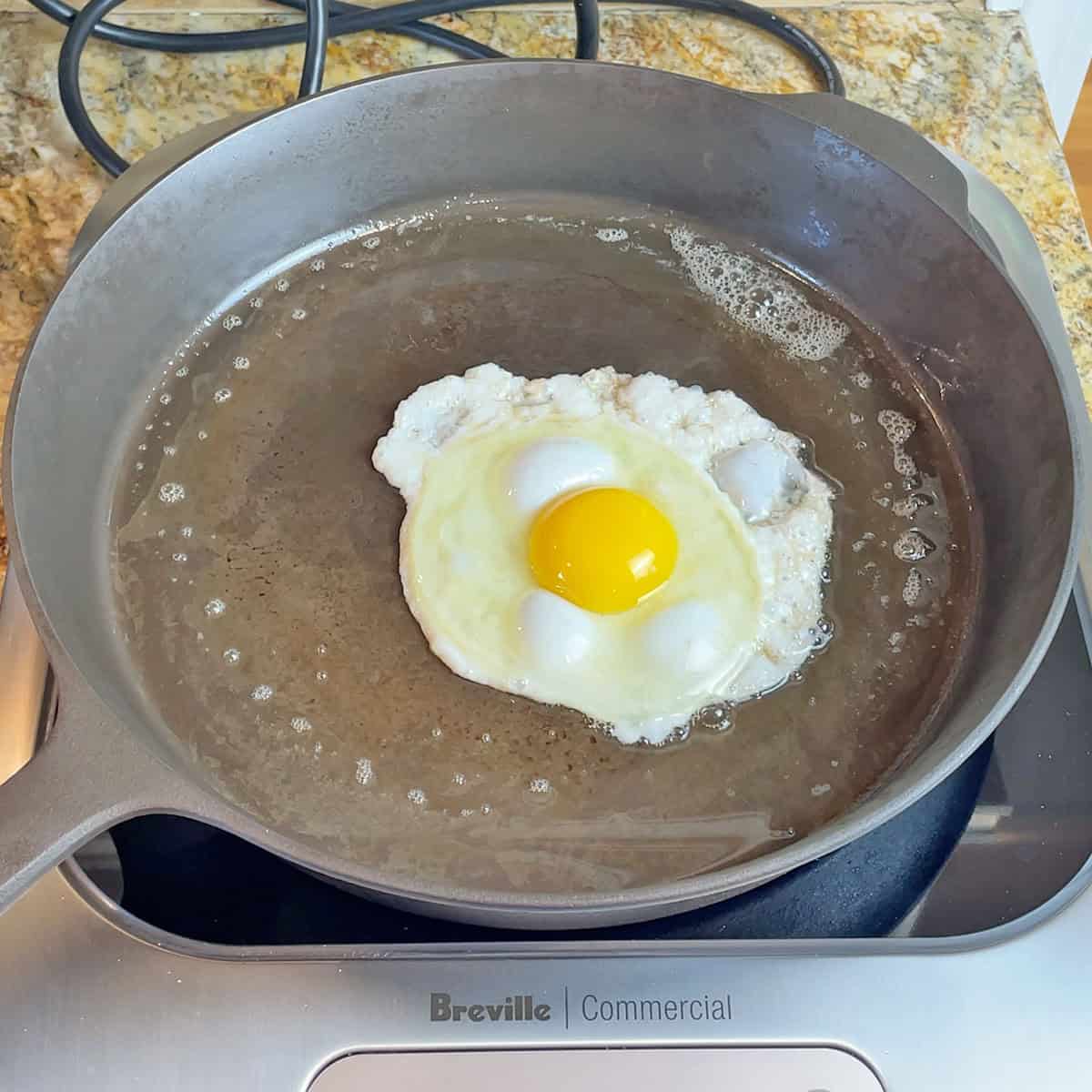 Cooking an egg on a Field Company pan on an induction cooktop