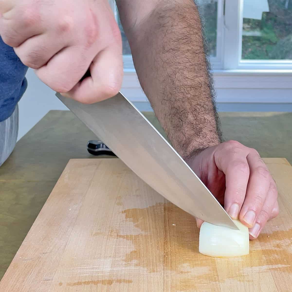 Cutting an onion with high tip of Zwilling Pro at an awkward angle