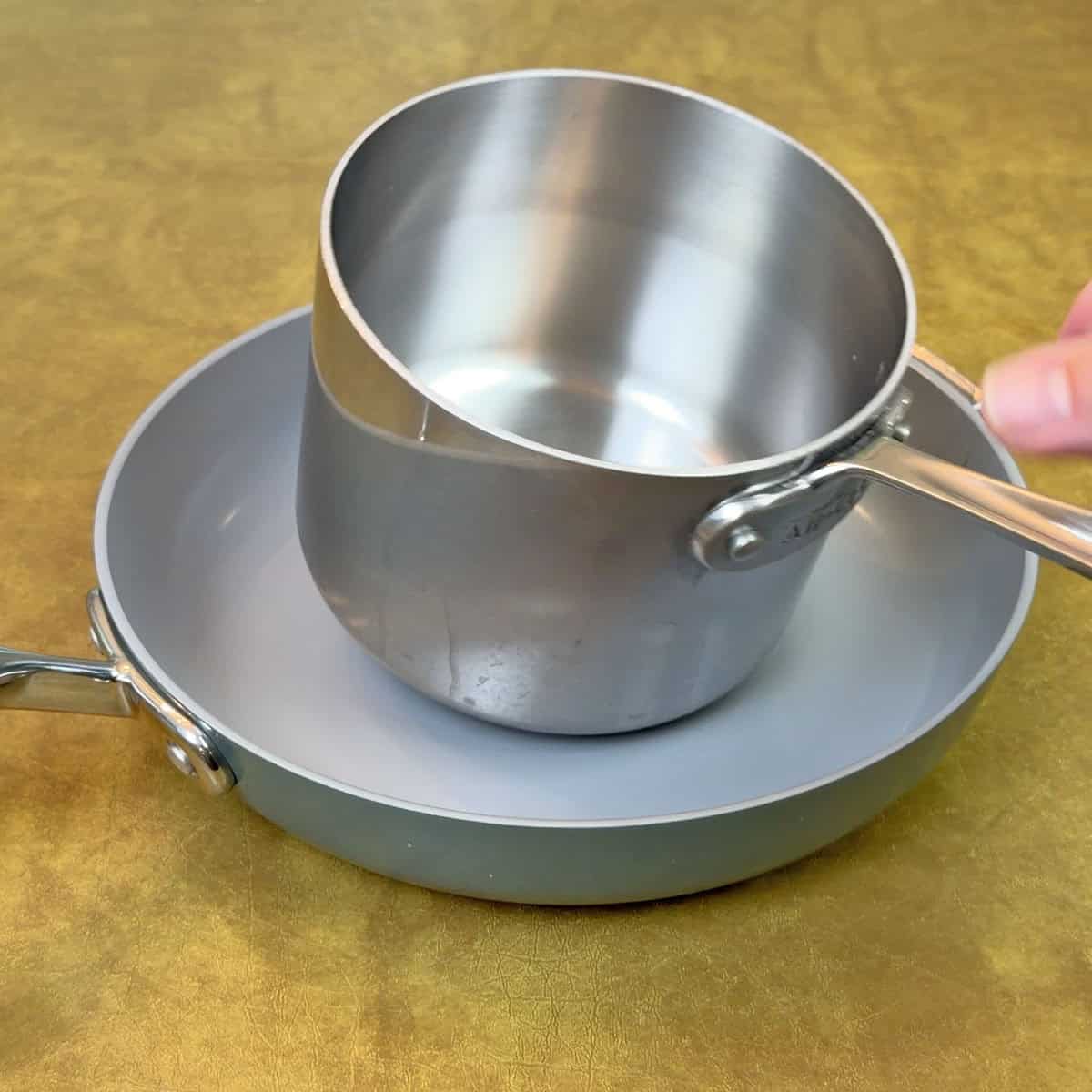 Dropping a 2 pound saucepan on Ninja NeverQuit pan cooking surface 20 times