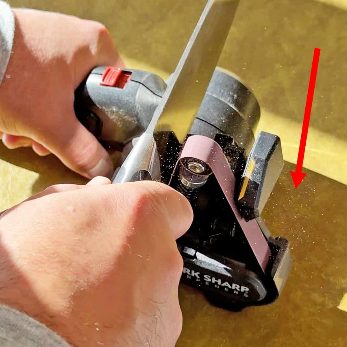 Electric belt sharpener metal dust flying in air