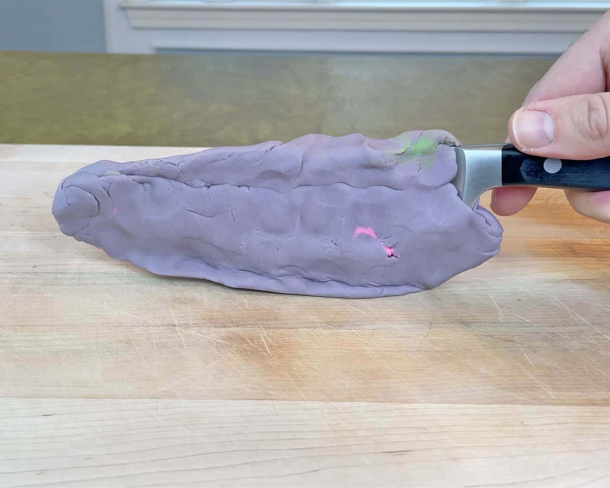 Knife with Play-Doh blade to illustrate how blades made of soft steel dull quickly