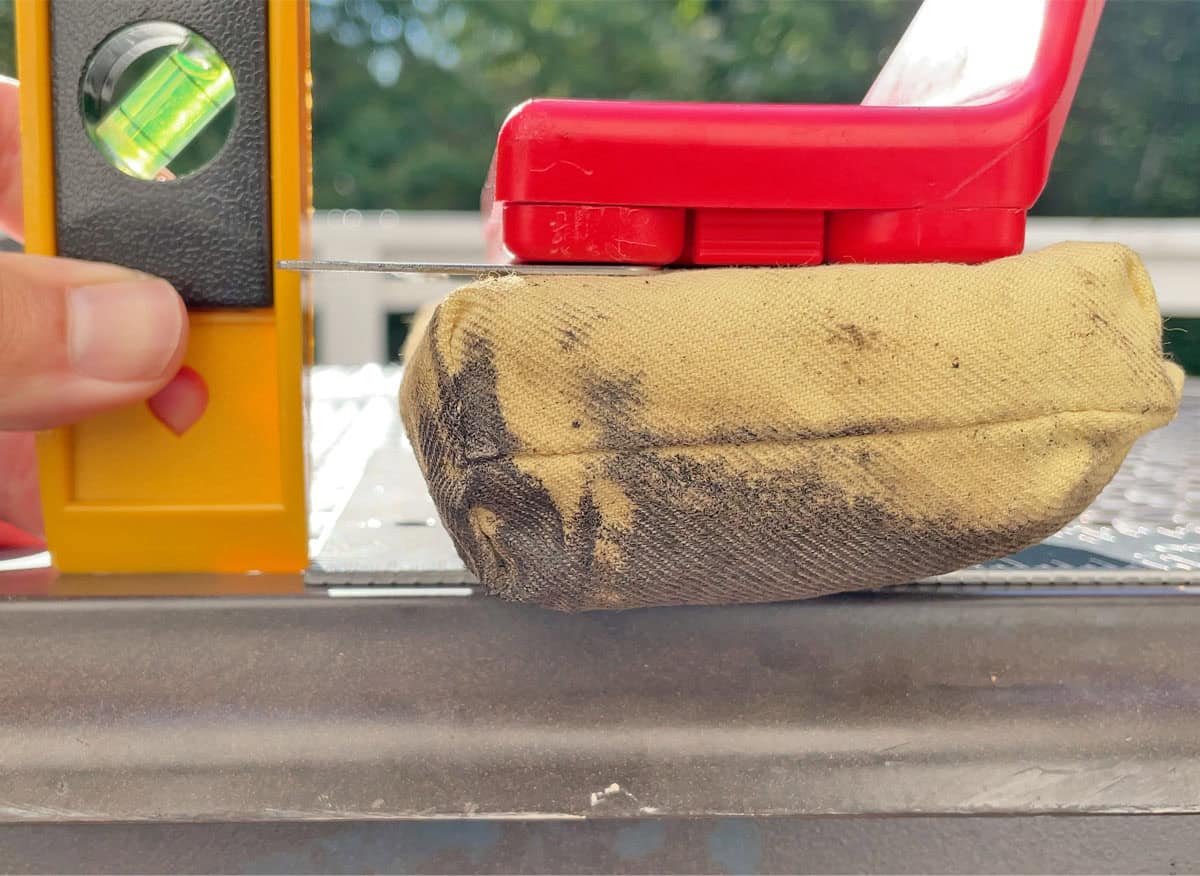 Measuring how close to the back edge of the grill each brush can reach