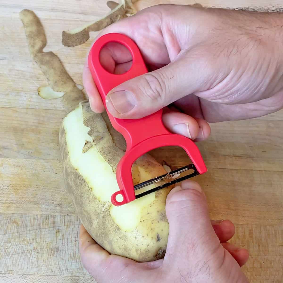 Peeling a potato with the Kuhn Rikon Original Swiss Peeler