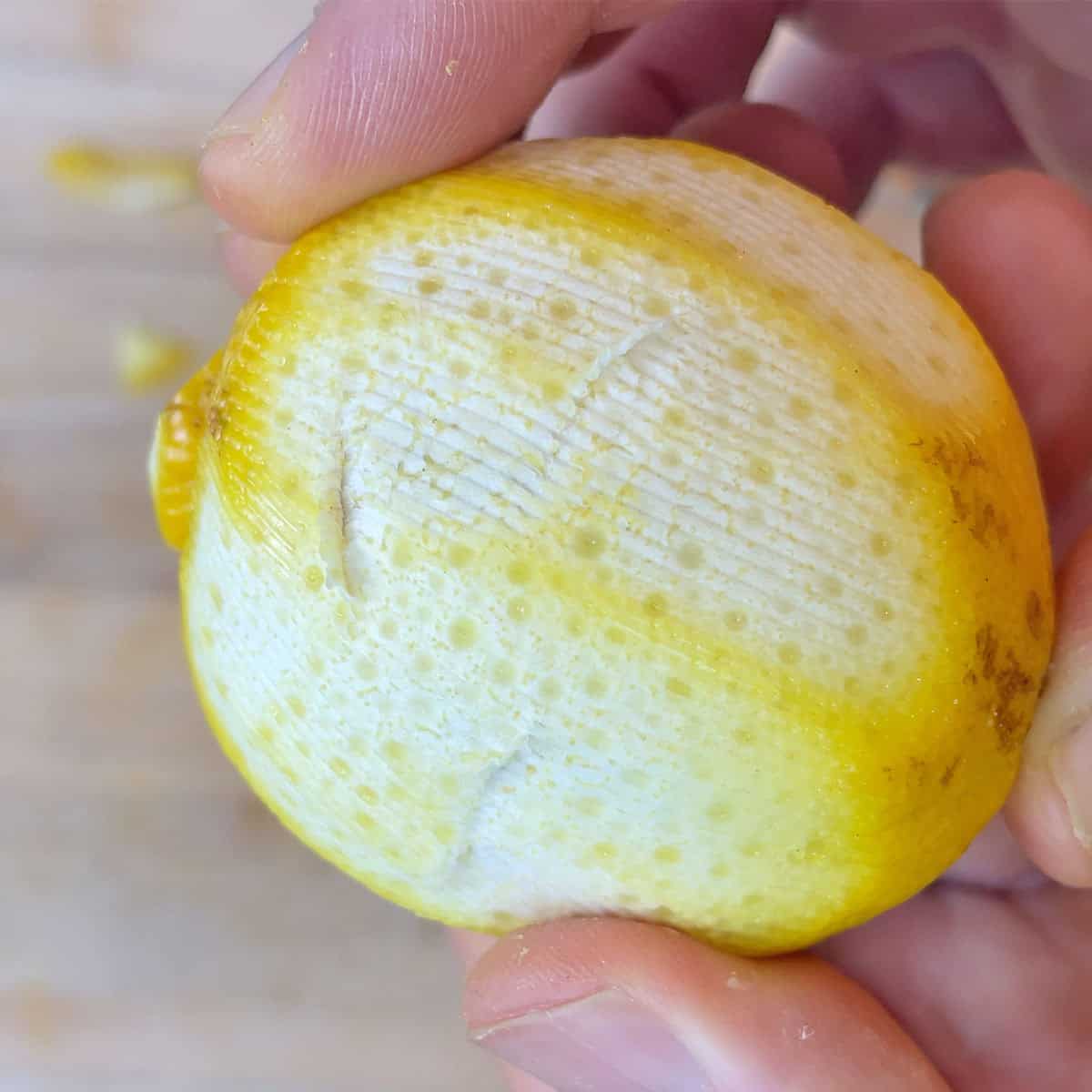 Peeling chunks out of a lemon with the OXO serrated peeler