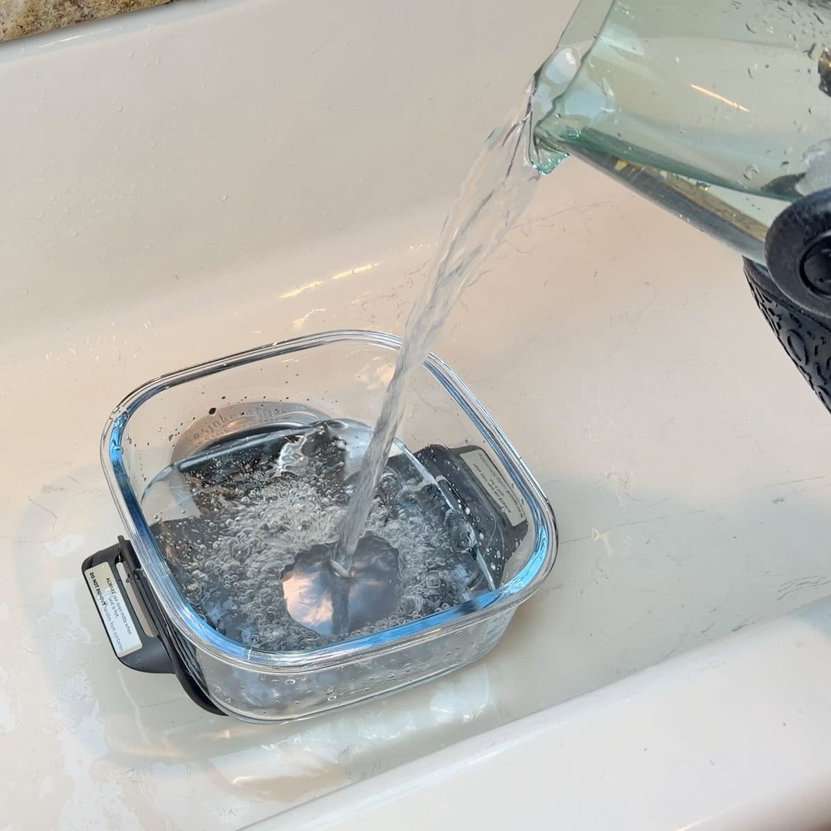 Pouring ice water on hot Ninja Crispi glass container