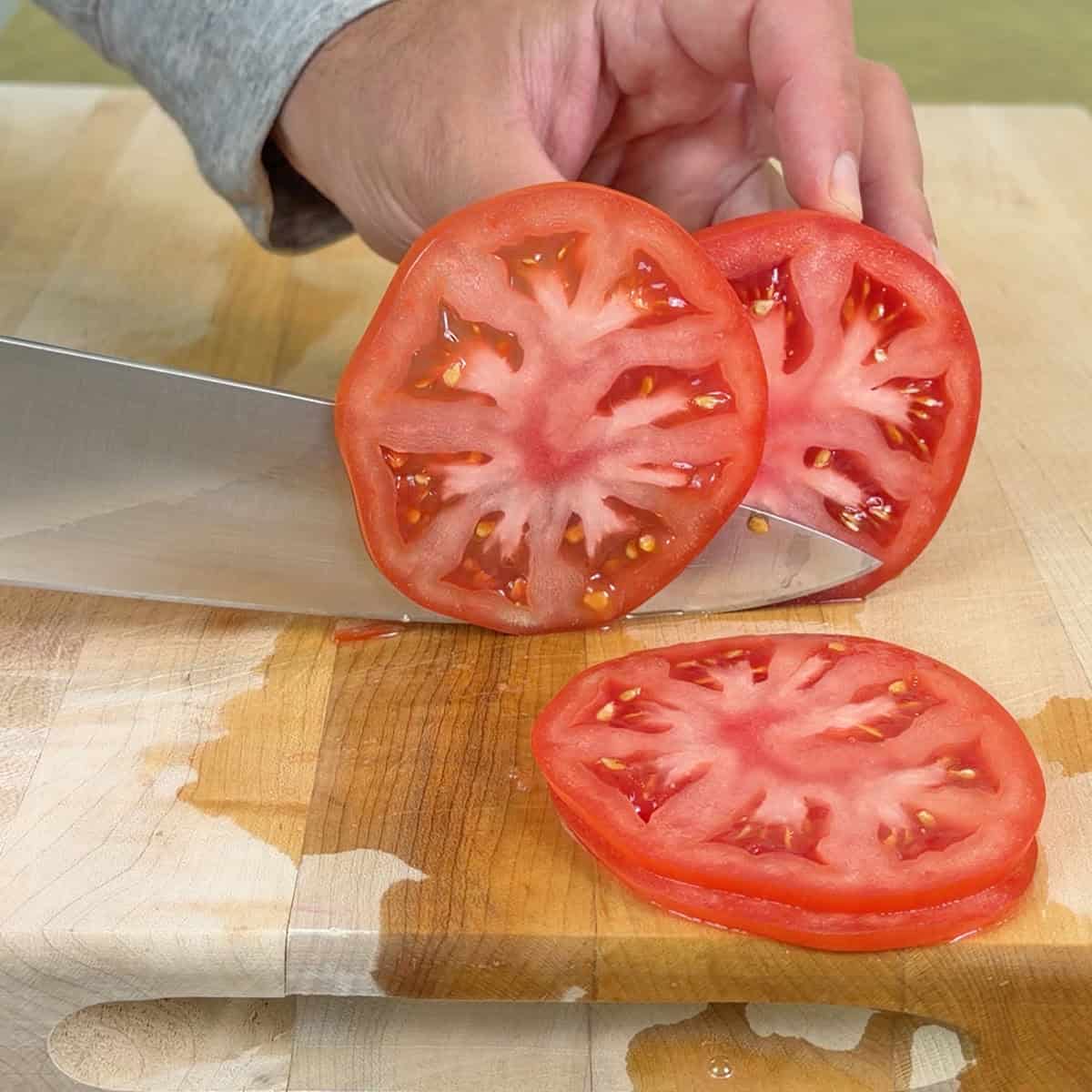Slicing a tomato with a knife sharpened with the ChefsChoice electric sharpener