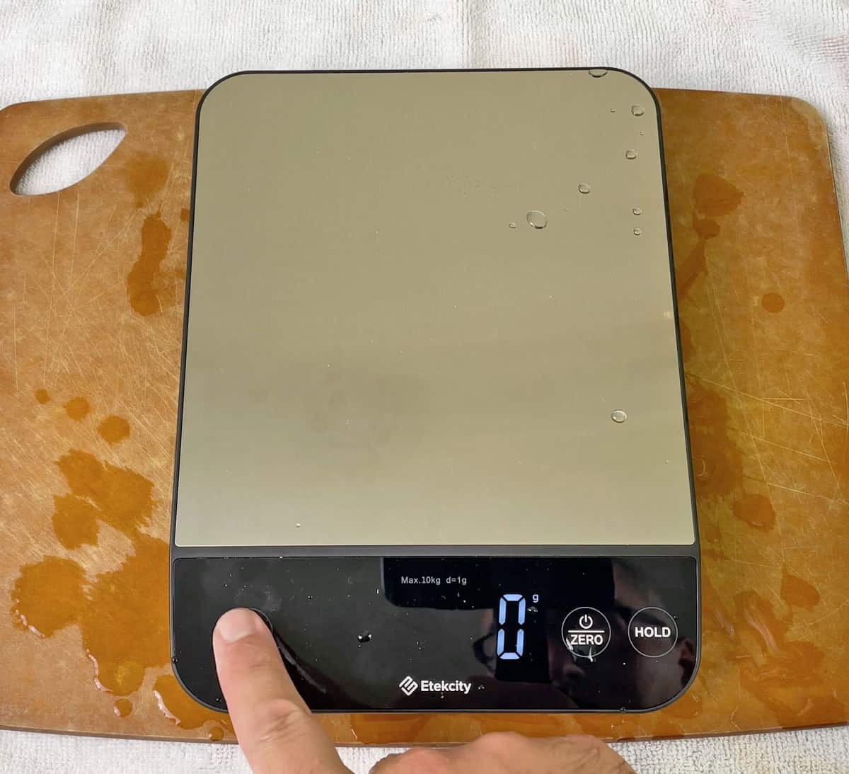 Testing kitchen scale buttons with wet hands