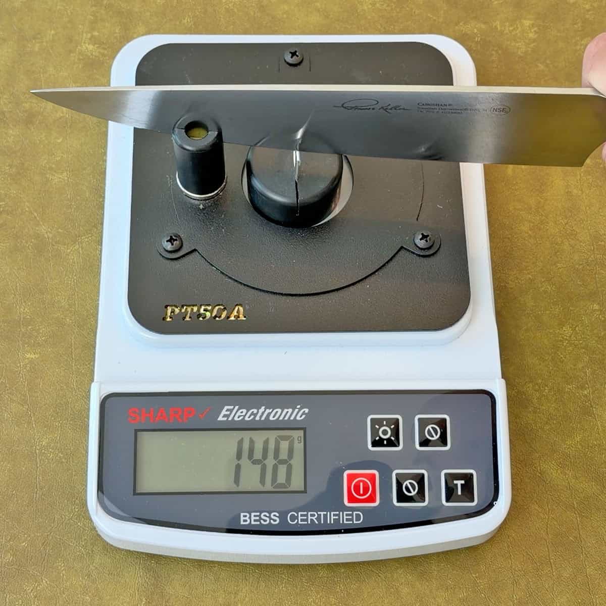 Testing sharpness of a Cangshan Thomas Keller knife after sharpening with a whetstone