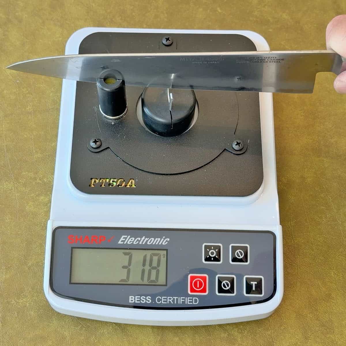 Testing sharpness of a Miyabi knife after sharpening with a manual pull through sharpener