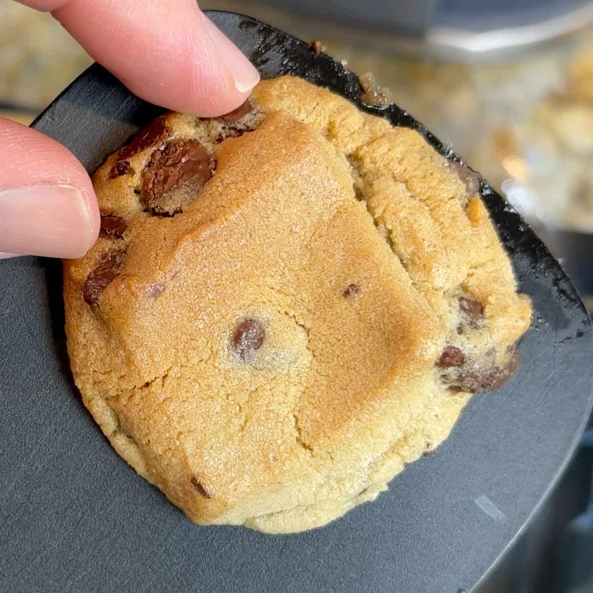 Chocolate chip cookie with visible chocolate chunks and a golden-brown crust.