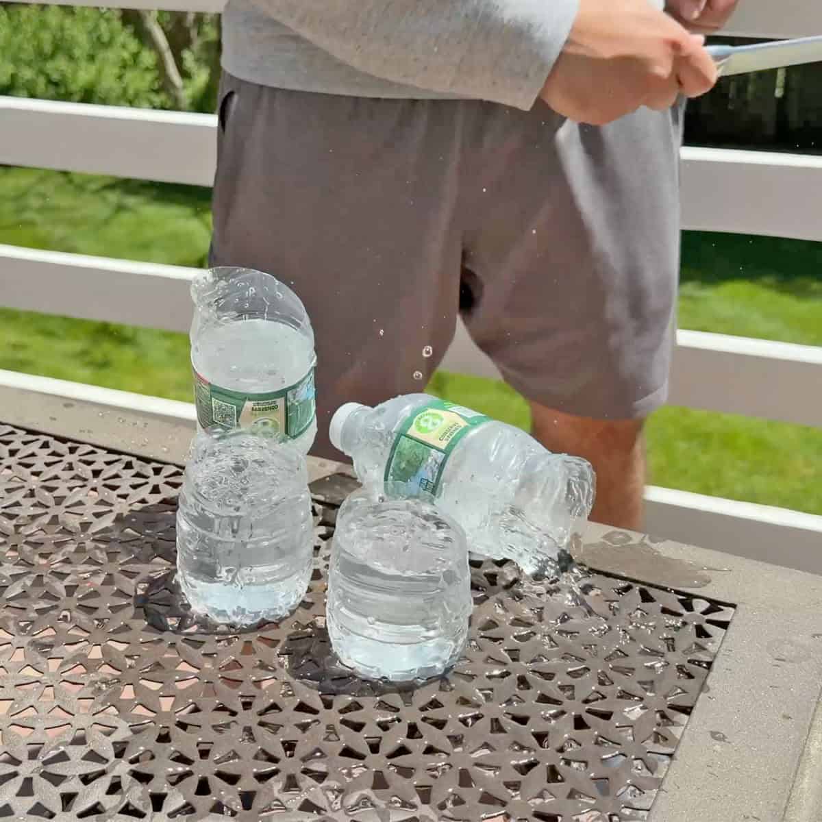 Water bottles cut in half with knife sharpened with ChefsChoice electric sharpener