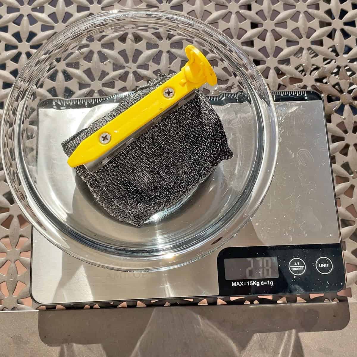 Weighing BBQ Daddy sponge after soaking in water for 30 seconds
